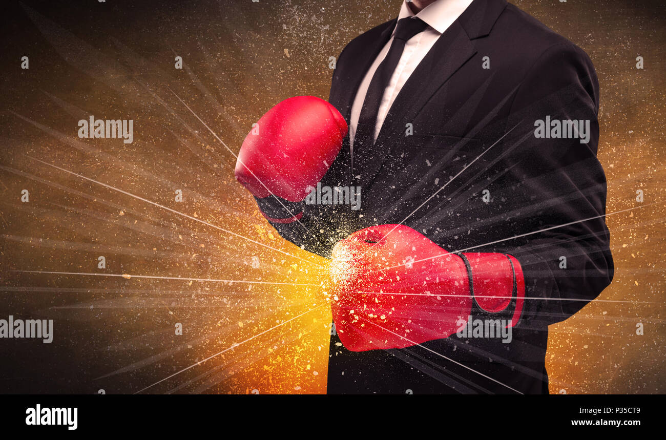 A successful powerful business person in red boxing gloves concept with ...