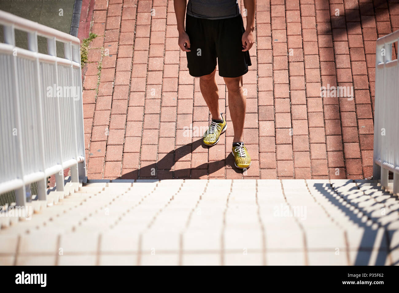 young asian adult male athlete standing in front of steps ready for speed and strength training. Stock Photo