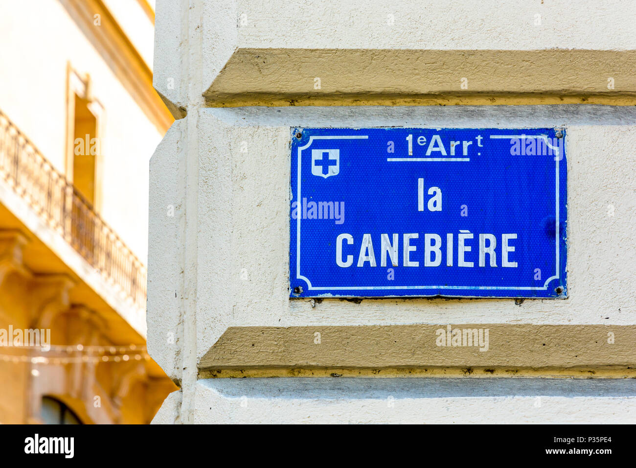 Close-up view of the street name sign of La Canebiere, the historic high street and most famous avenue in Marseille, France, mounted on the corner of  Stock Photo
