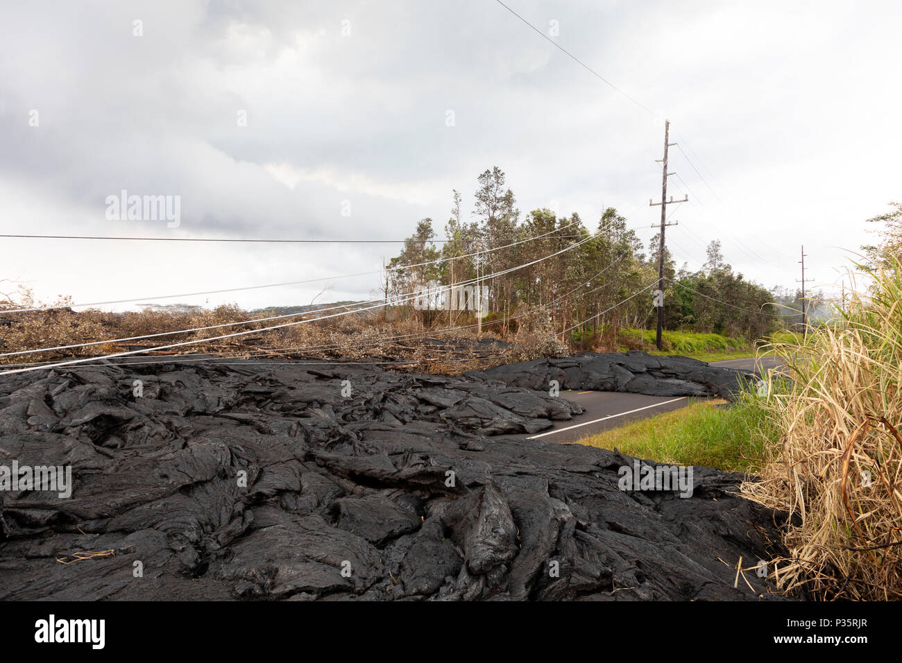 High voltage power line destroyed by a lava flow in Hawaii Stock Photo