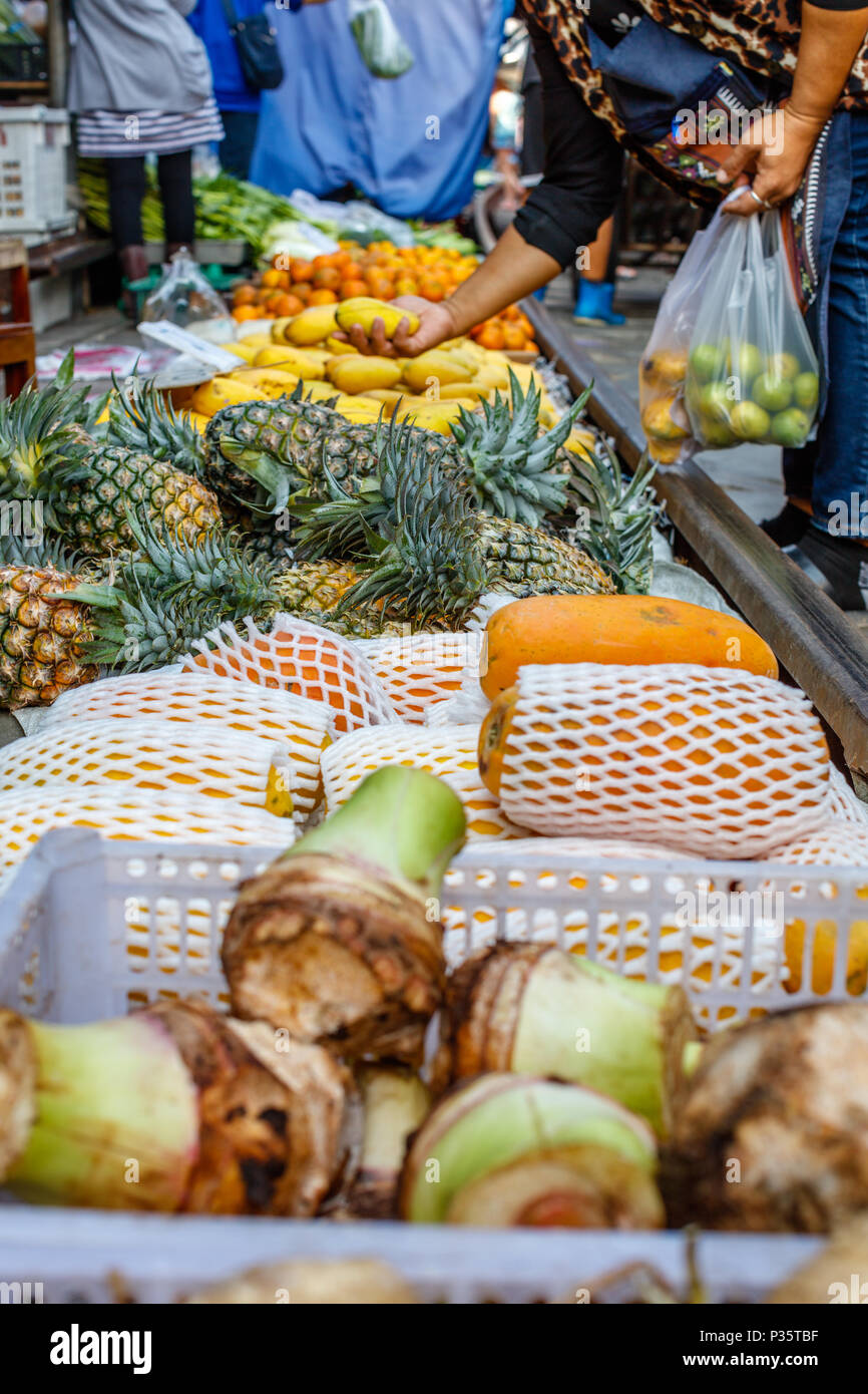 Fruit and vegetables at a famous Maeklong railway market in Bangkok, Samut Songkhram province, Thailand. Vertical image Stock Photo