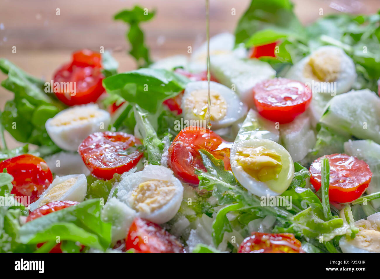Dieting salad with lettuce, cherry tomatoes, cucumber and quail eggs Stock Photo