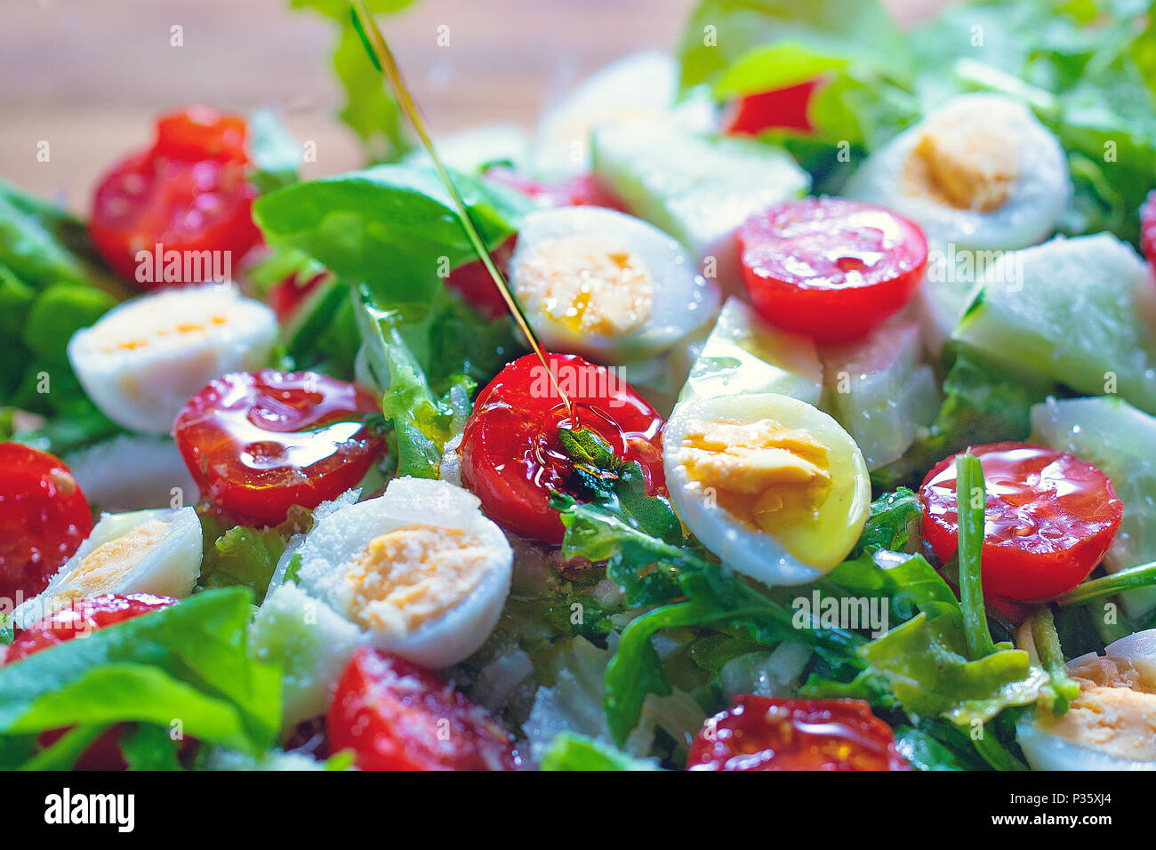 Dieting salad with lettuce, cherry tomatoes, cucumber and quail eggs Stock Photo
