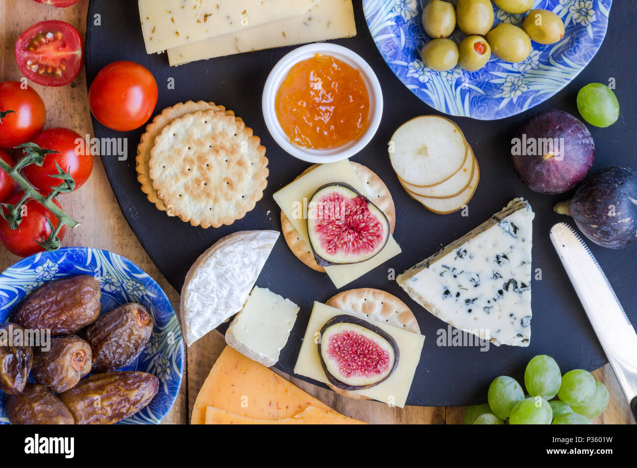 Cheese board close up with assortment of cheese, crackers, fruit and