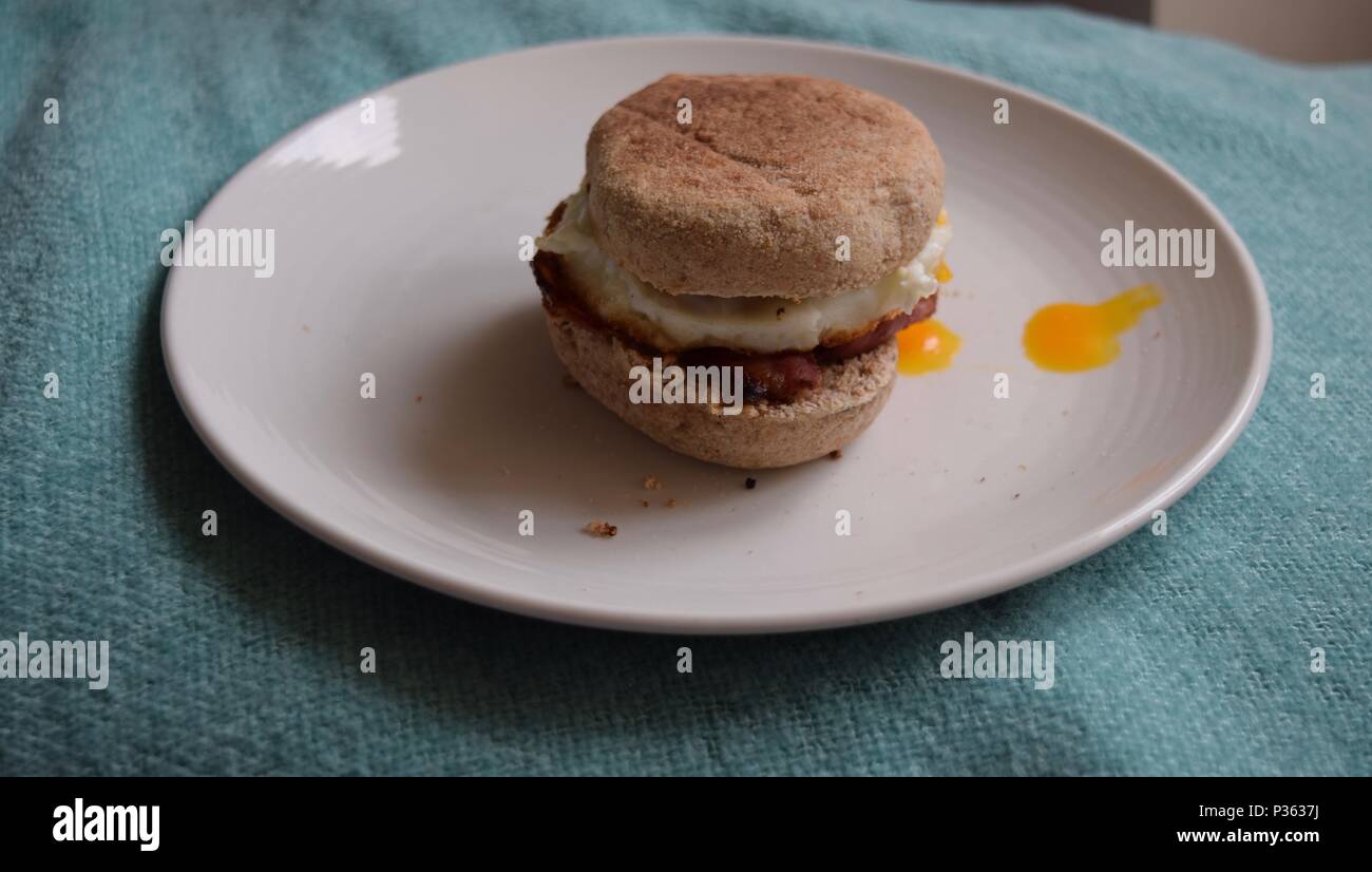 English muffin with runny egg and fried bacon Stock Photo Alamy