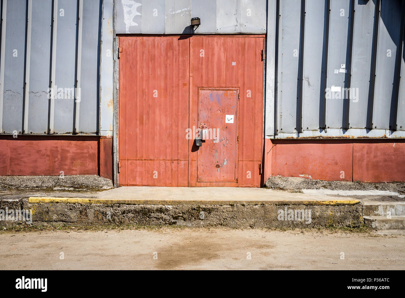 Old metal warehouse door, hangar gate. Industrial iron door. Stock Photo