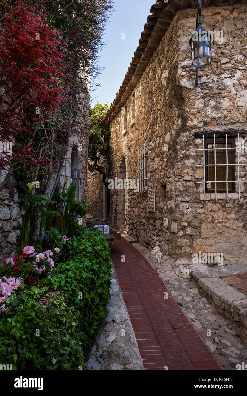 Narrow street and stone house in medieval Eze village on French Riviera ...