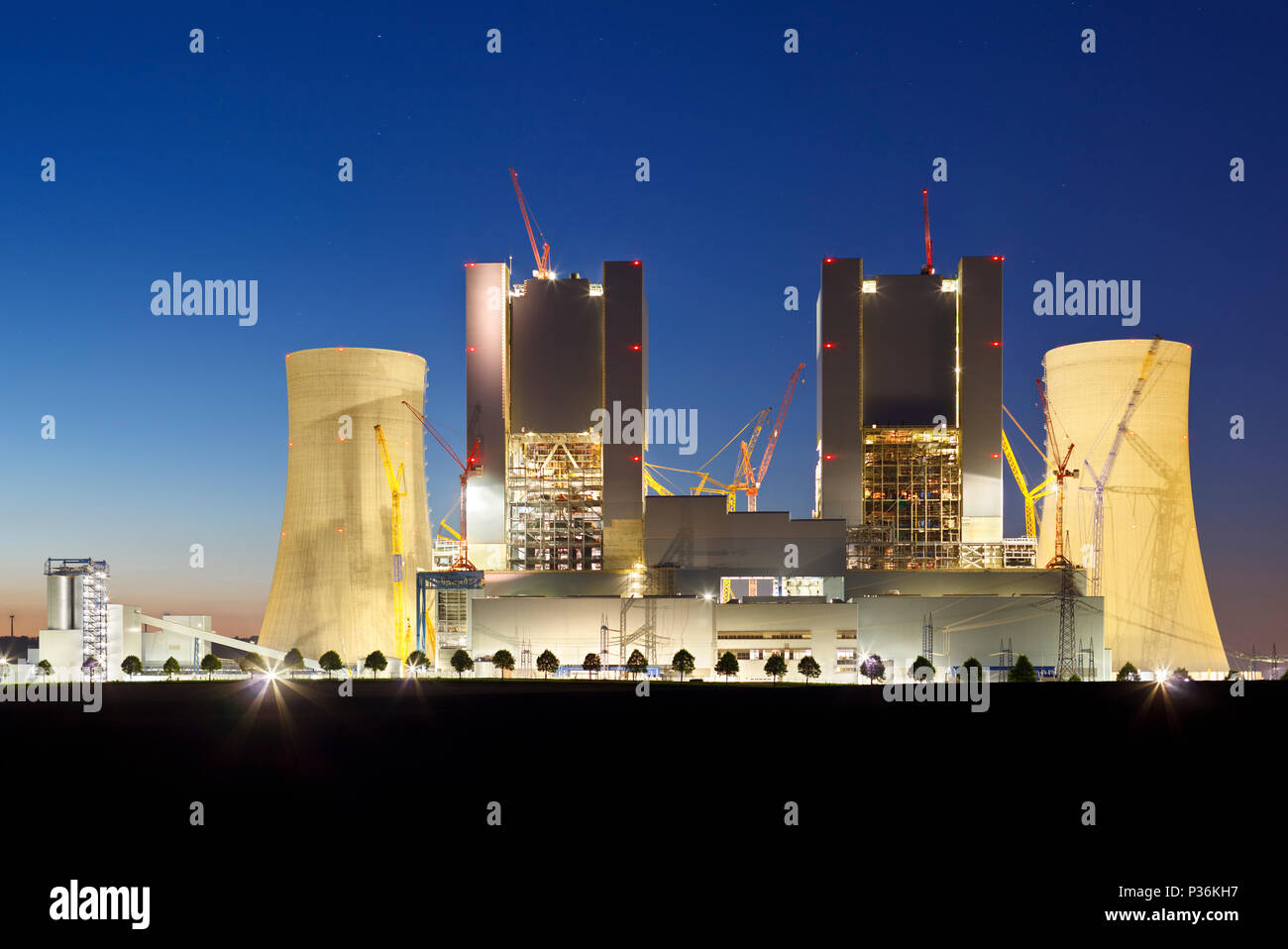 Construction site of a new brown coal power plant at night. Stock Photo