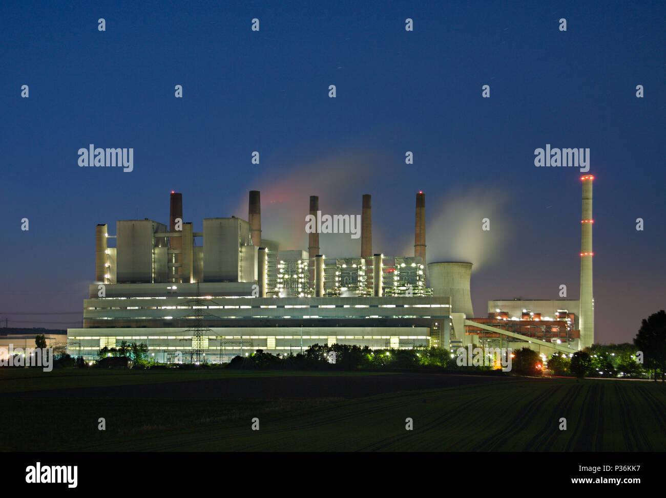 A giant brown coal power plant with night blue sky. Stock Photo