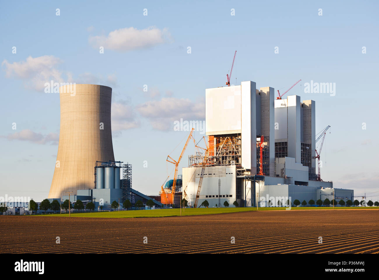 Construction site of a new brown coal power plant in evening light. Stock Photo