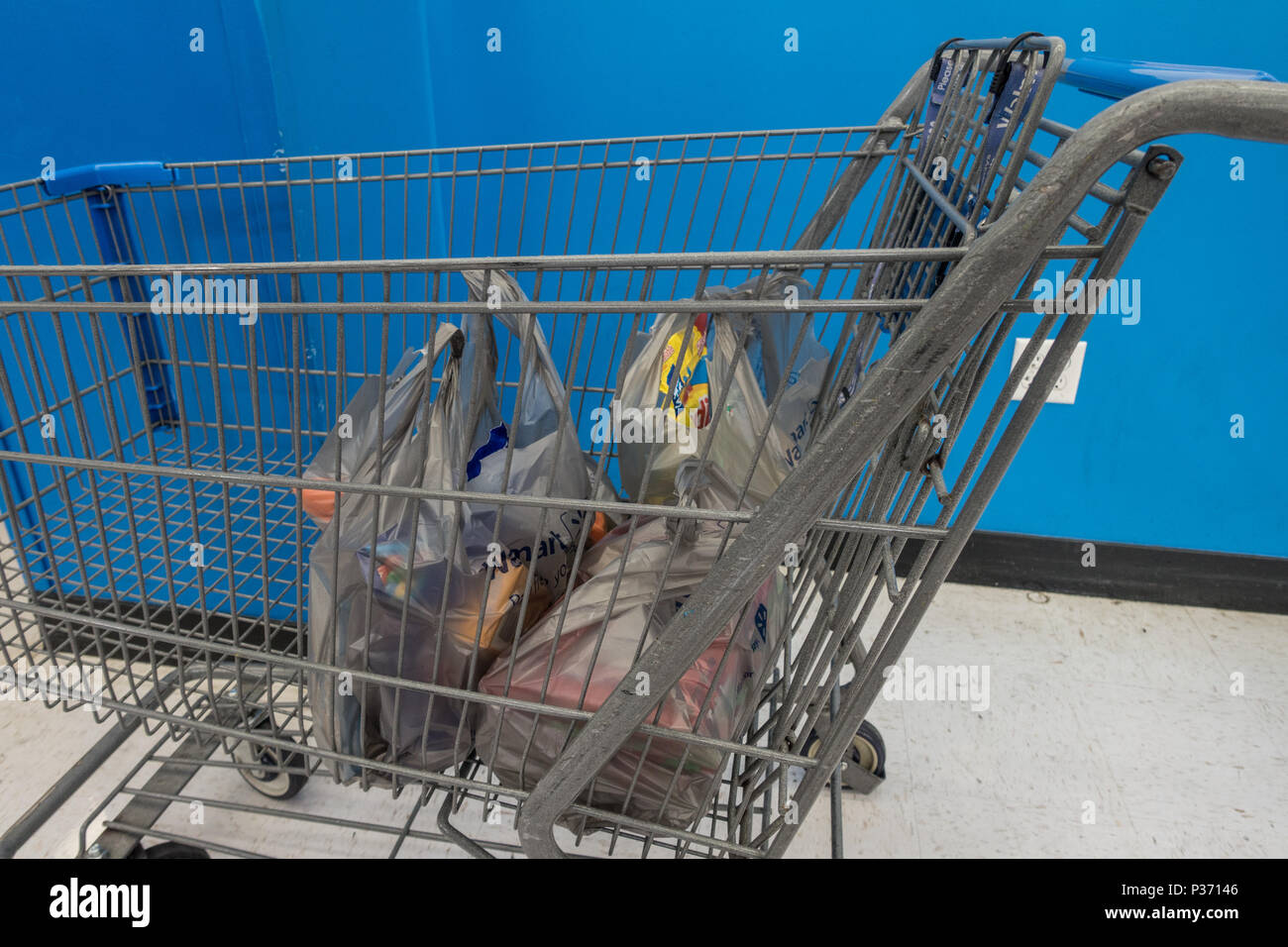 Grocery shopping in plastic shopping bags placed in a trolley in