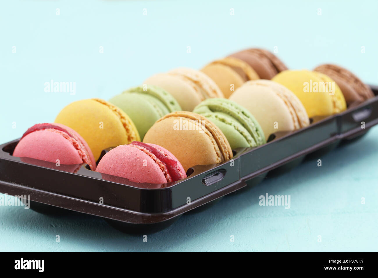 Selection of colorful macaroons in plastic box Stock Photo