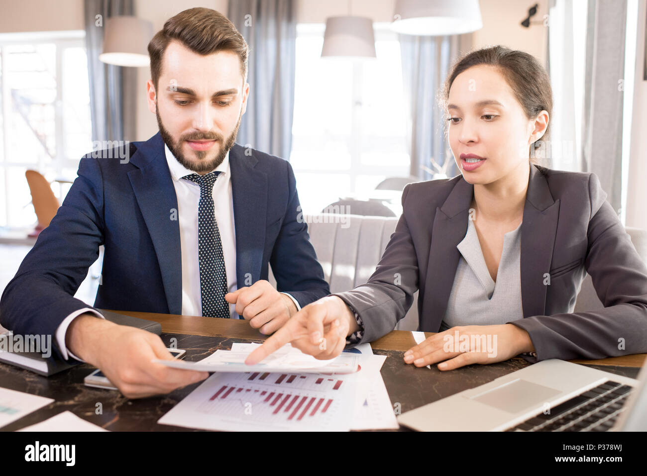 Busy managers analyzing data report Stock Photo