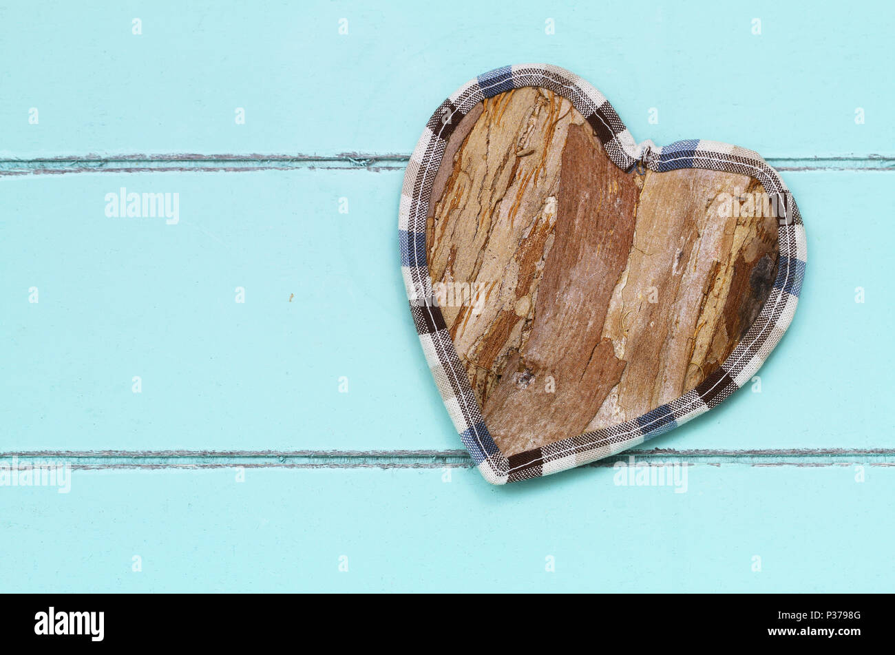 Wooden heart on blue wood with copy space Stock Photo