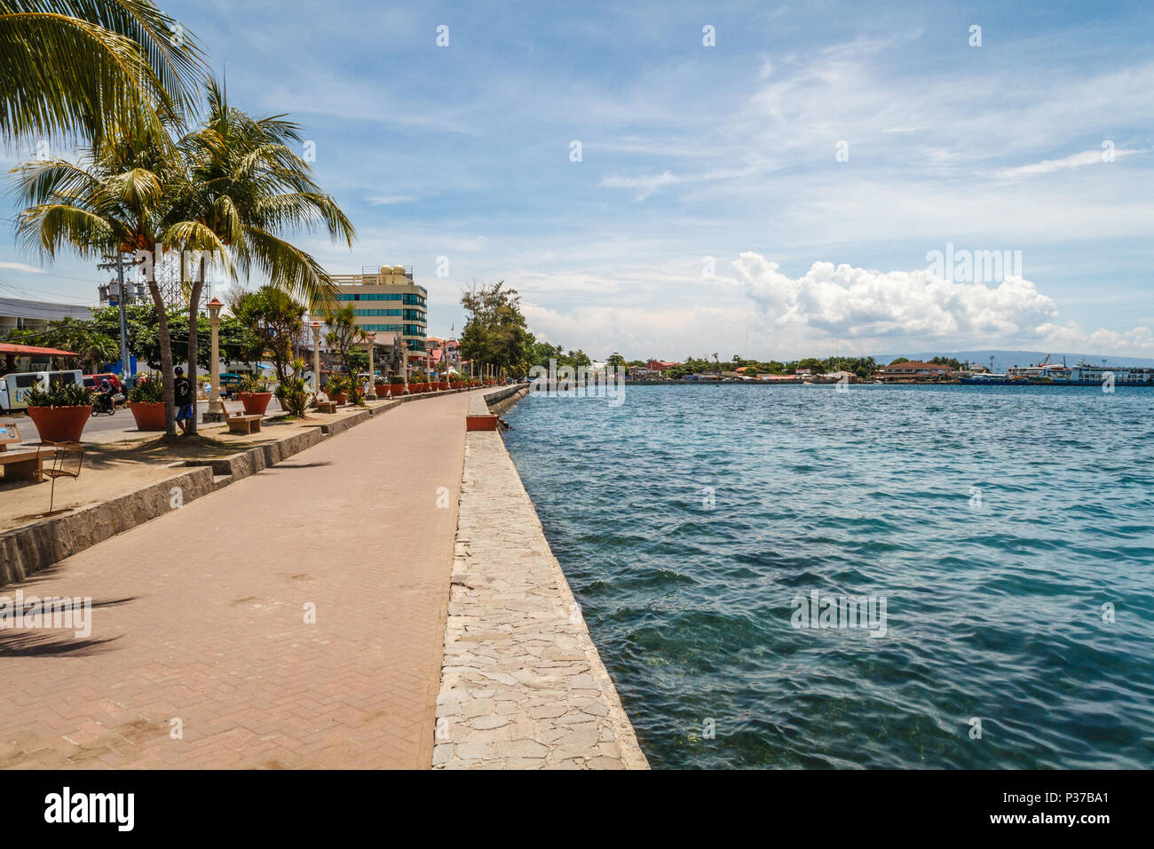 The promenade along Rizal Boulevard with palm trees and sea view, City of Dumaguete, Philippines Stock Photo