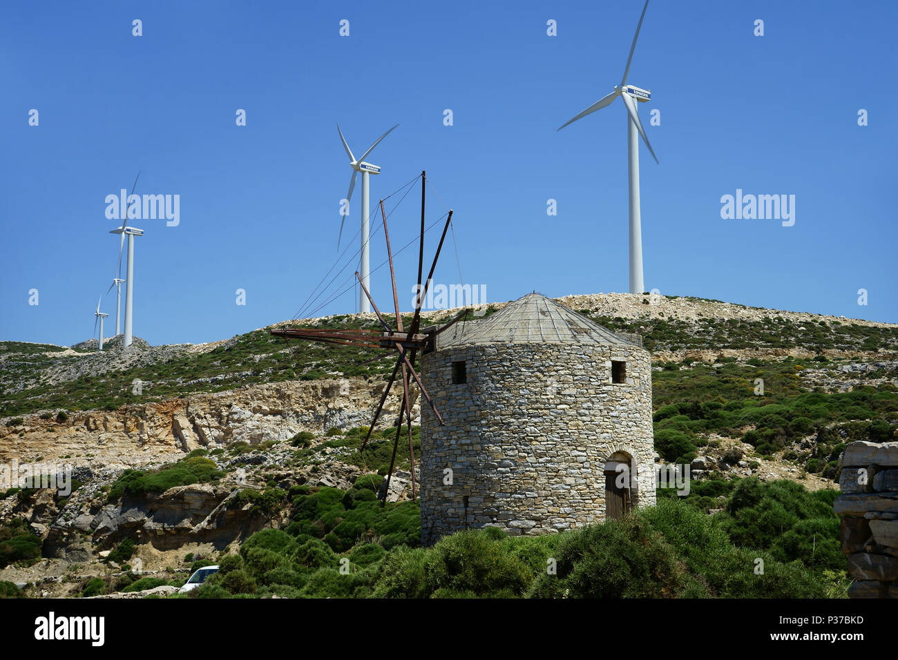 Old windmill with modern windturbines, island Naxos, Cyclades, Greece Stock Photo