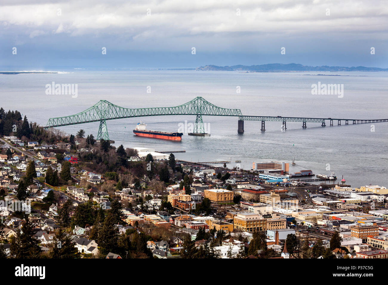 OR02475-00...OREGON - Cargo ship passes under the Astoria Bridge entering Young's Bay at the town of Astoria located next to the mouth of the Columbia Stock Photo