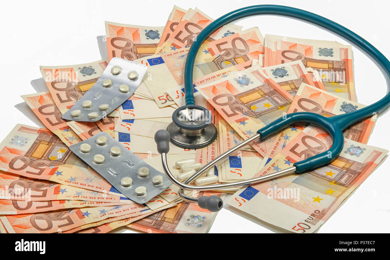 Stethoscope and pills on a big stack of euros Stock Photo