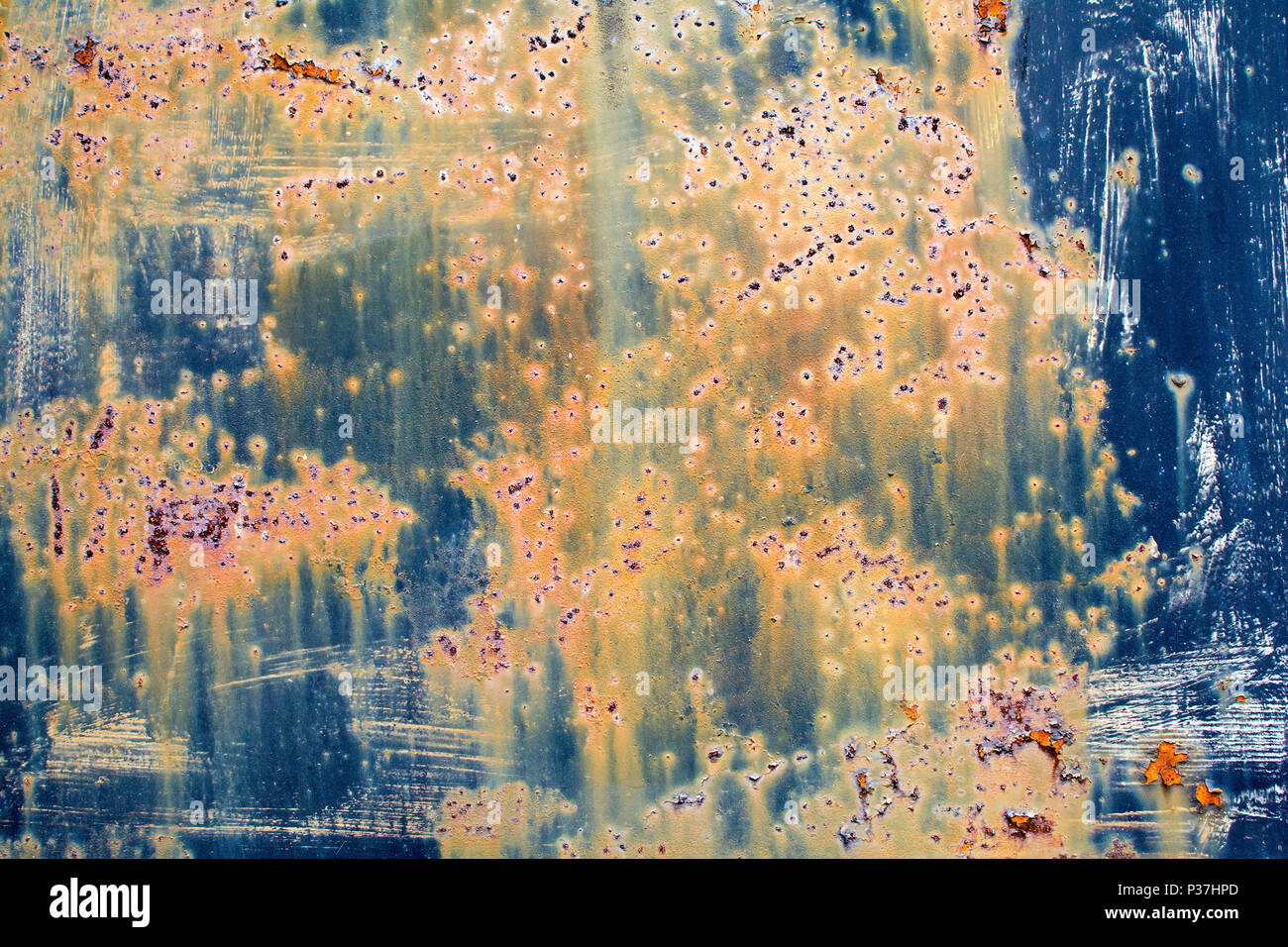 Rusty, run down, multicolor metal door in closeup Stock Photo