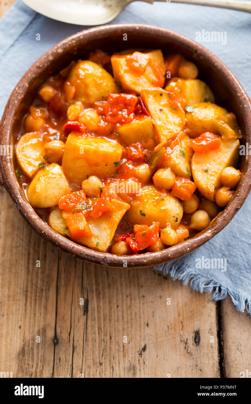 Patatas bravas. Roasted potatoes with chickpeas in tomato sauce Stock