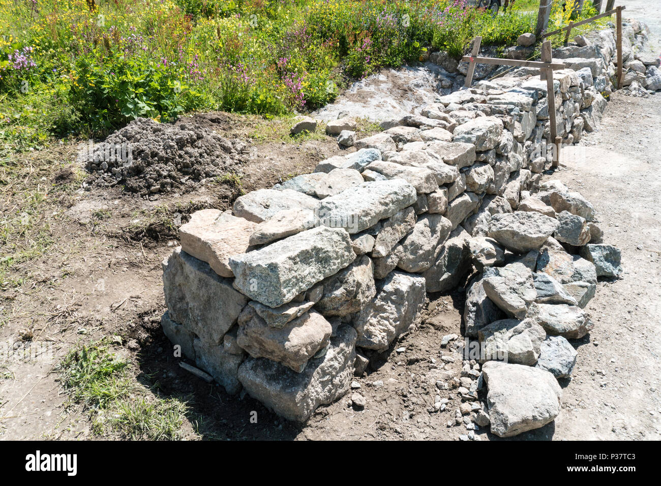 traditional rock wall construction site with wooden frame in the Swiss Alps Stock Photo Alamy