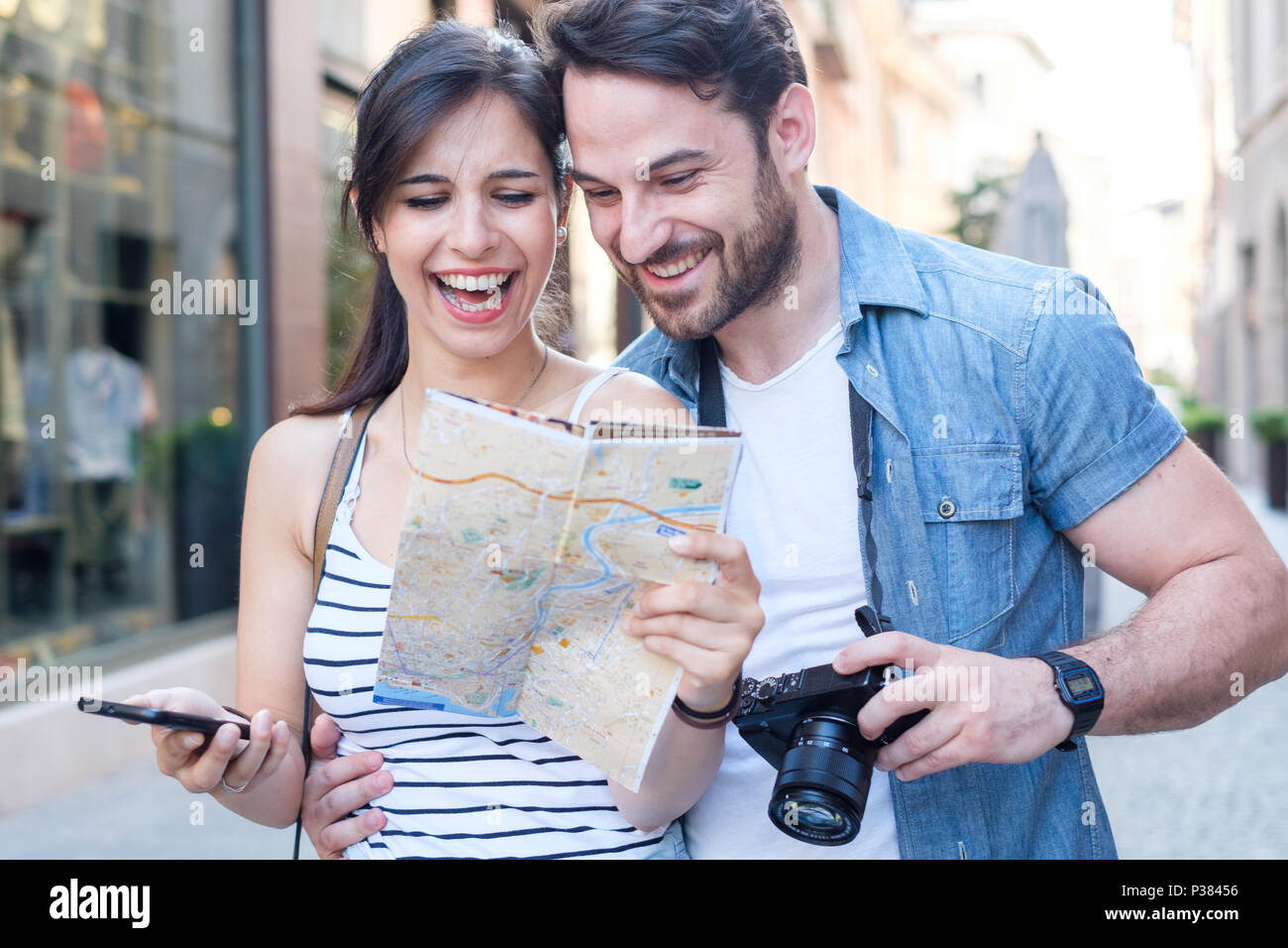 Young happy tourist couple visiting travel destination city Stock Photo