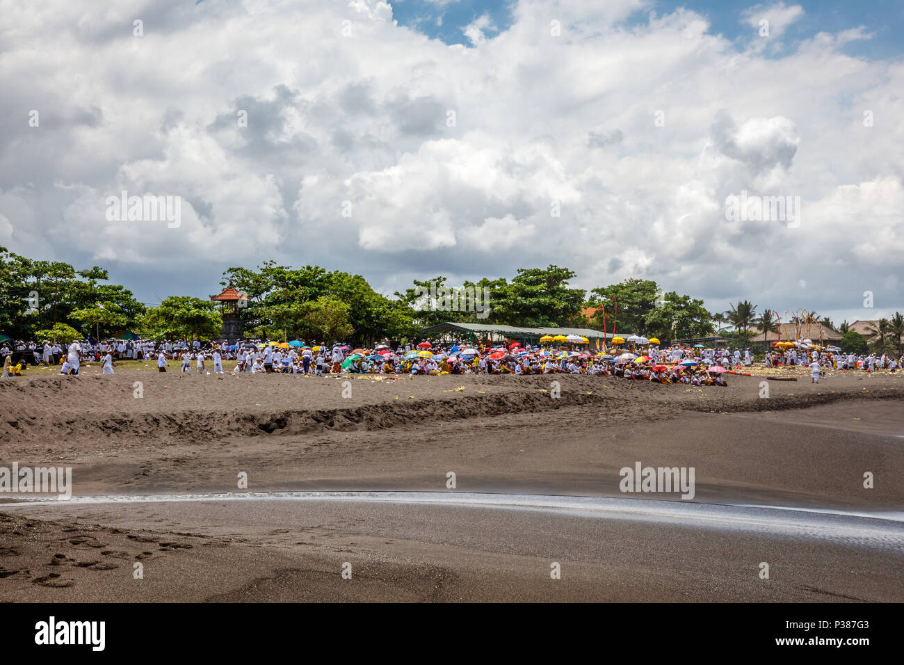 Seseh Beach (Pantai Seseh), Bali, Indonesia. March, 14, 2018. People praying on the beach during Melasti, Balinese Hindu ceremony of purification. Stock Photo