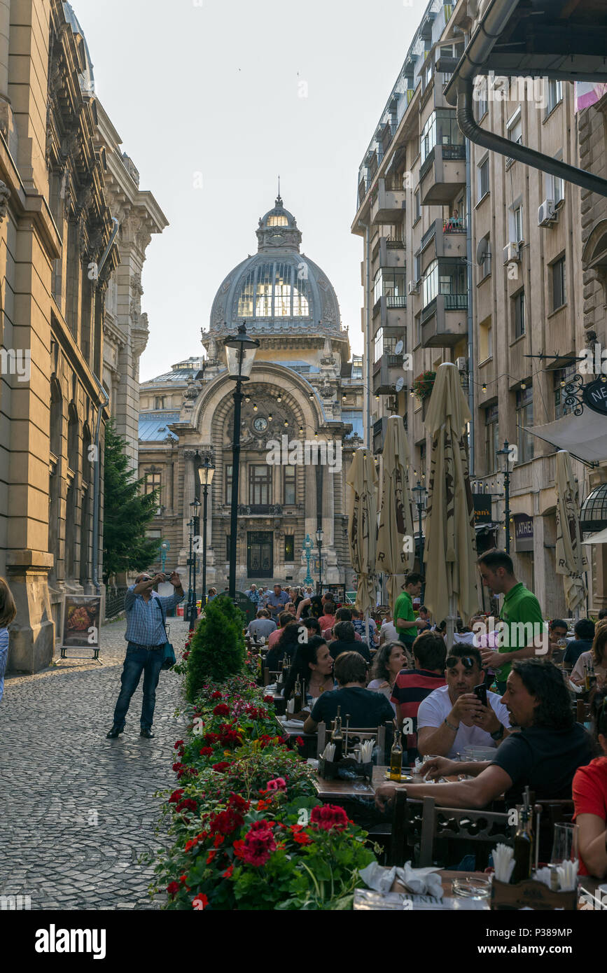 BUCHAREST, ROMANIA - JUNE 2, 2018:  terraces on a busy street in the center of Bucharest, in the background the Stock Exchange Palace Stock Photo