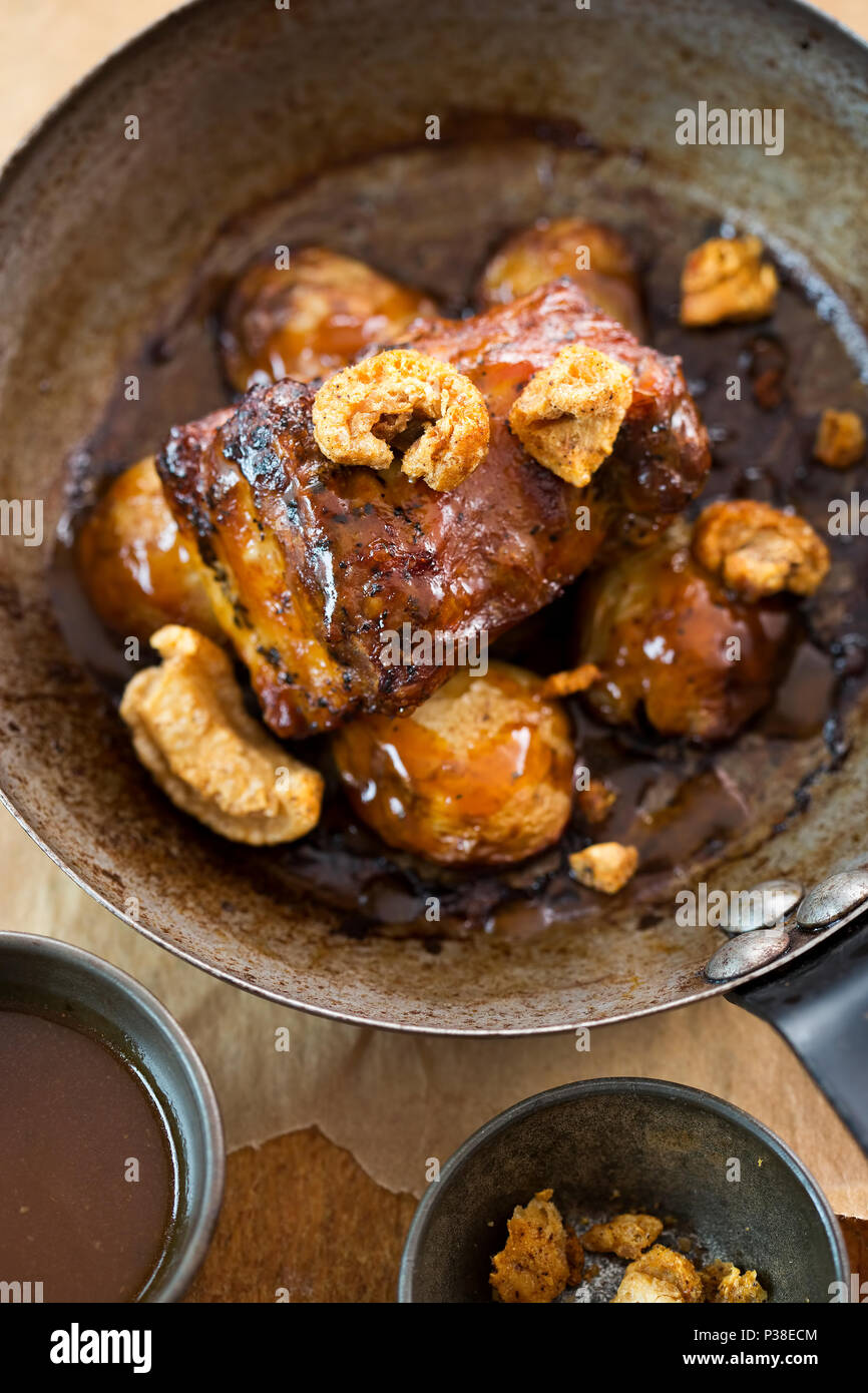 Slow cooked pork belly with crackling and pork jus & baby potatoes Stock Photo Alamy