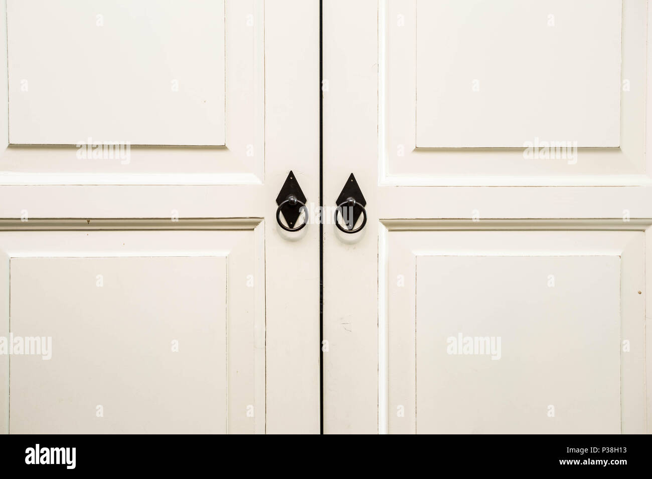 Vintage white wooden cupboard doors with metal handles Stock Photo Alamy