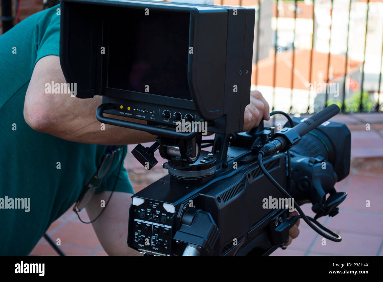 Camera operator working his equipment video hires stock photography