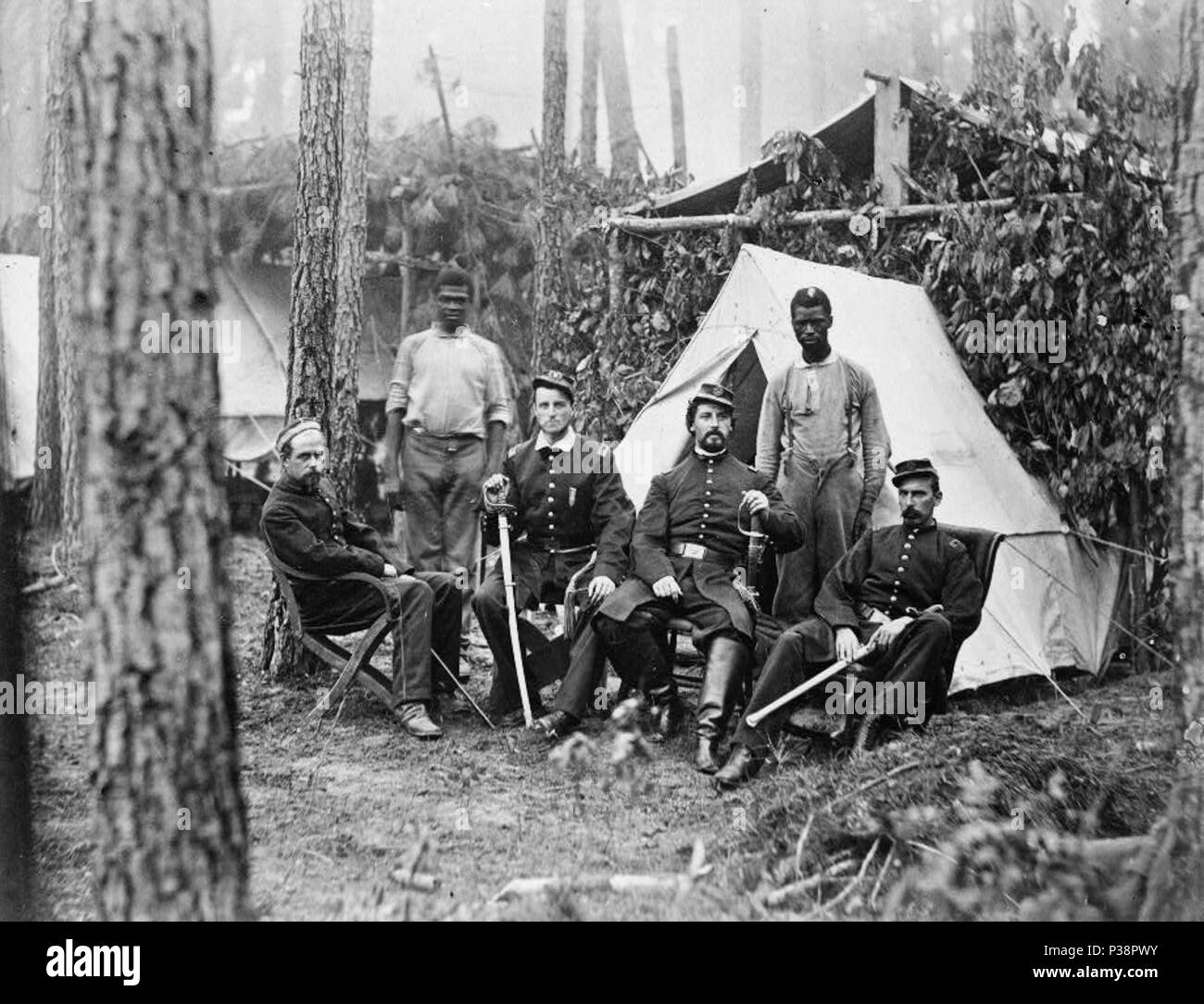 . Officers of 114th Pennsylvania Infantry in front of Petersburg, Va., August, 1864. Four union officers in front of tent, with two Afro-American Servants(?). 1864 3 Officers of 114th Pennsylvania Infantry 3c05798v Stock Photo