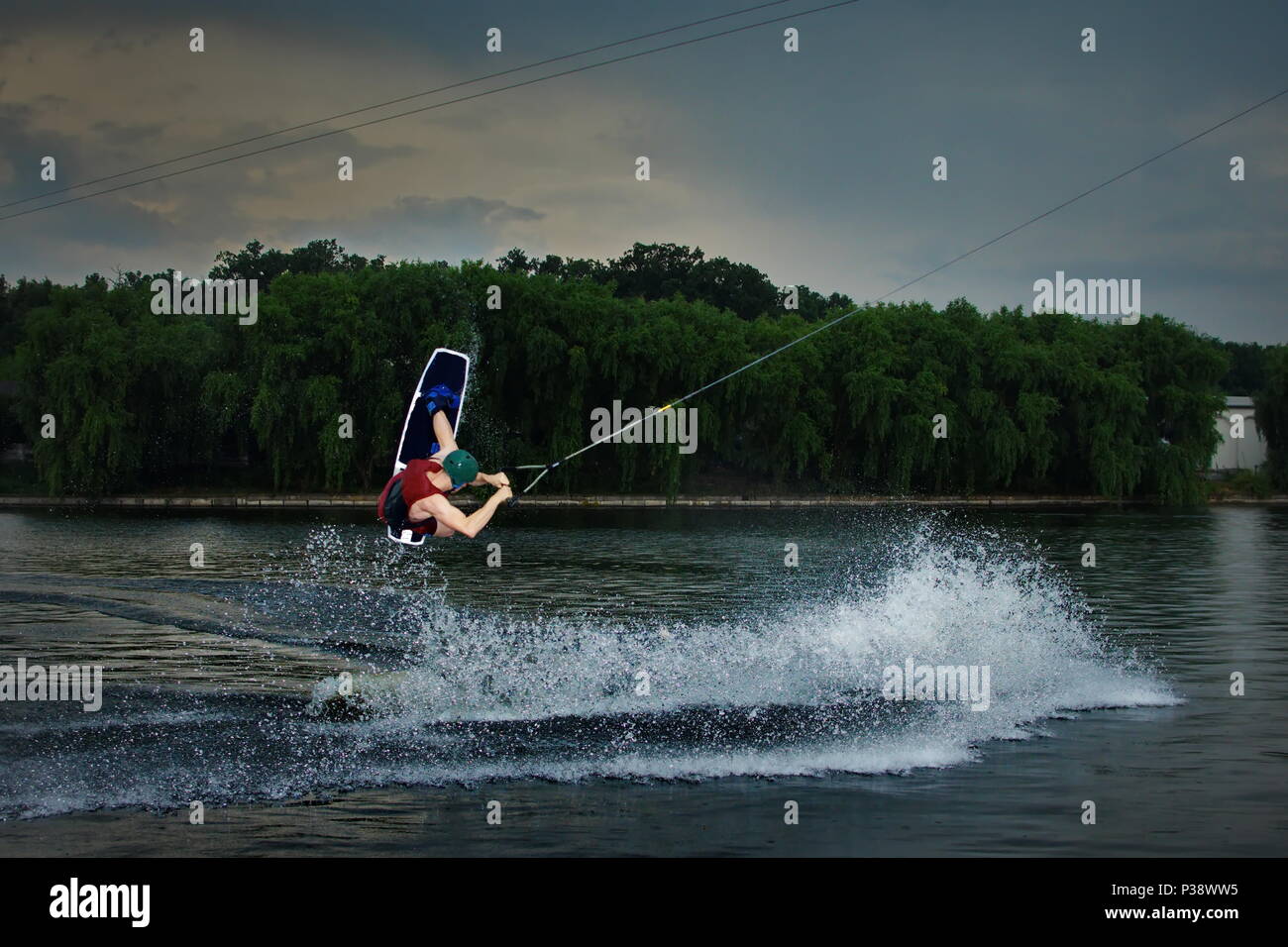 wakeboarder athlete doing wakeboard and wakeboarding jump Stock Photo