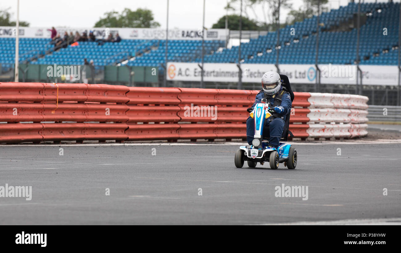 Silverstone GP circuit, UK. 17th Jun, 2018. During the HSCC Silverstone International race meeting Noel Wilson set out in his mobility scooter to set a new lap record on the full GP circuit. Aiming to raise £20,000 for MS research he is trying to set a record on every track in the country Credit James Wadham / Alamy Live News Stock Photo