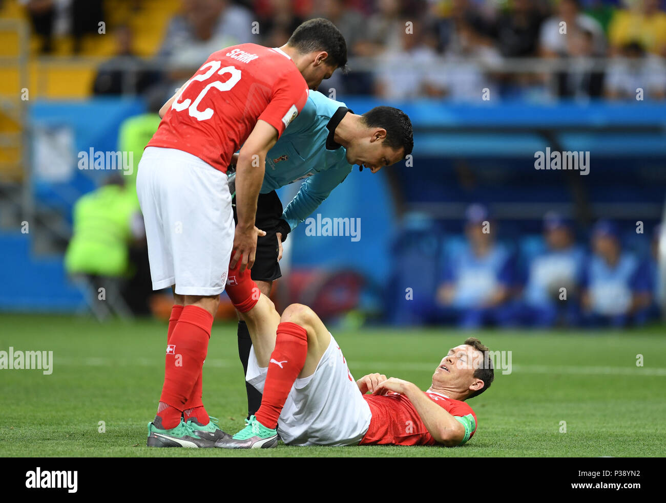 17 June 2018, Russia, Rostow am Don, Soccer, FIFA World Cup, Group E, Brazil vs Switzerland at the Don Stadium: Switzerland's Stephan Lichtsteiner lying on the ground. His team mate Fabian Schaer (L) and referee Cesar Arturo Ramos are with him. Photo: Marius Becker/dpa Stock Photo