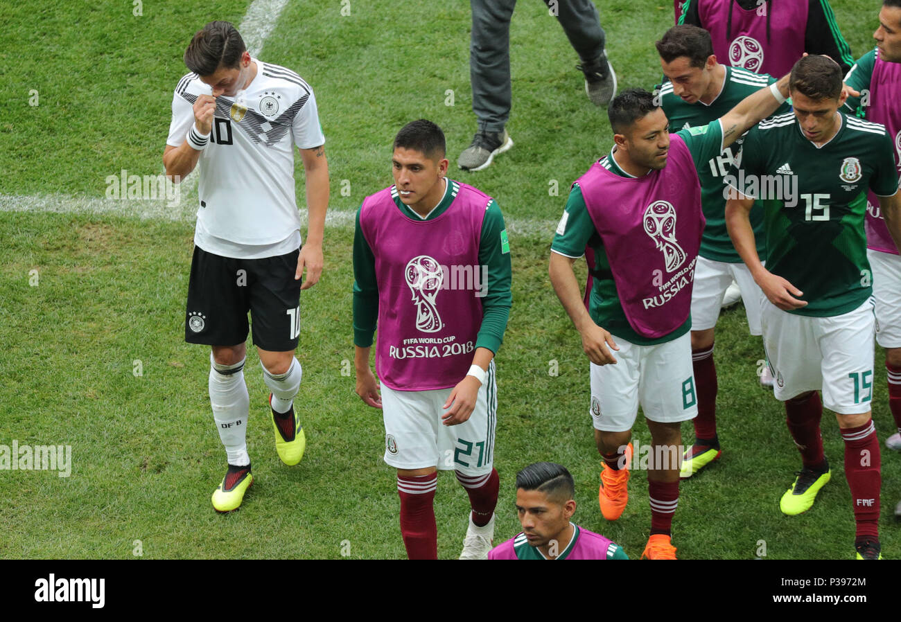 17 June 2018, Russia, Moscow, Soccer, FIFA World Cup, Group F, Matchday 1 of 3, Germany vs Mexico at the Luzhniki Stadium: Germany's Mesut Oezil (L) Mexican players leave the pitch at half-time: R-L, Hector Moreno from Mexico, Marco Fabian from Mexico, Edson Alvares, also from Mexico. Photo: Christian Charisius/dpa Stock Photo
