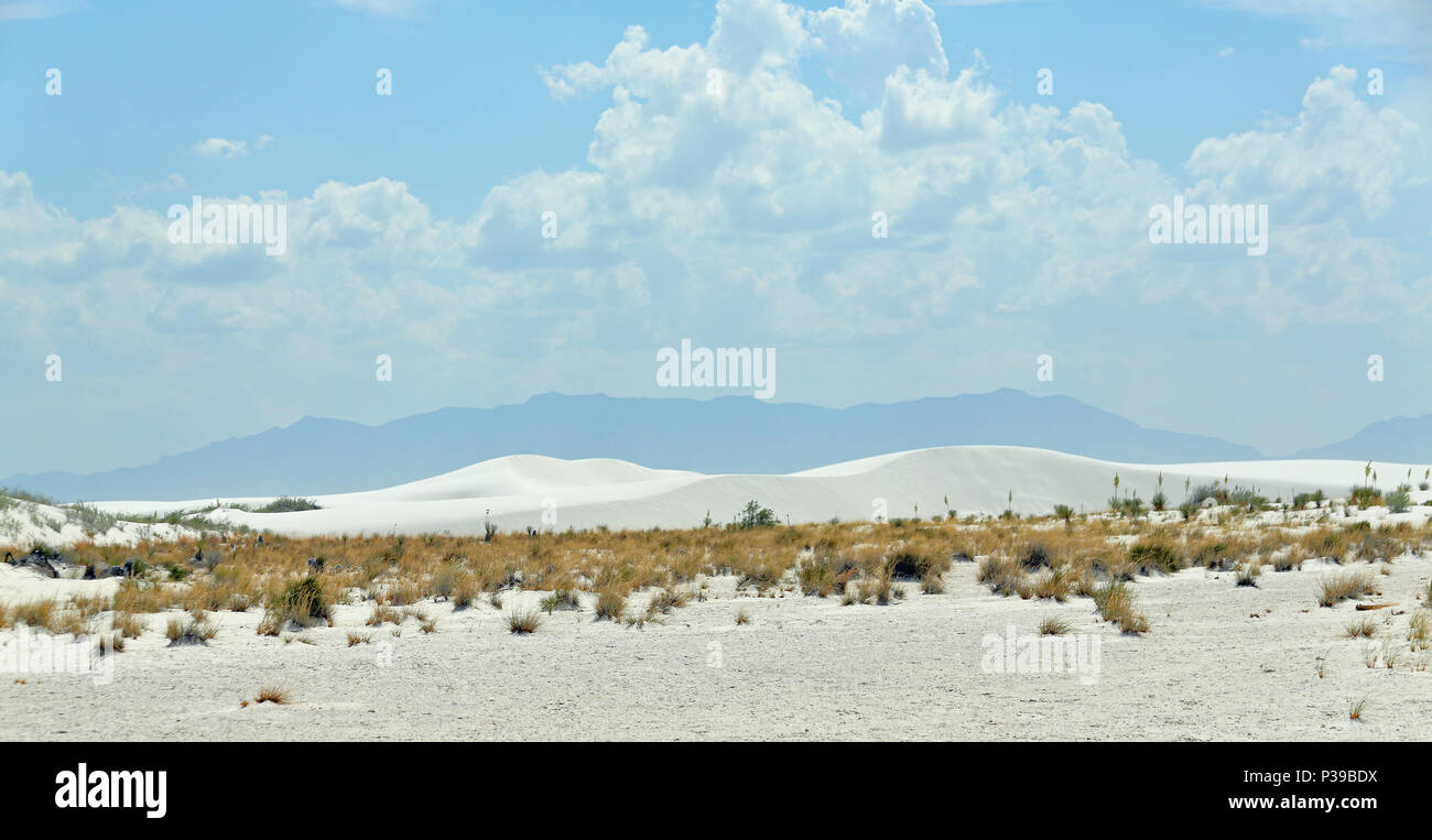 White sand dunes with mountains in the background in southern New Mexico Stock Photo