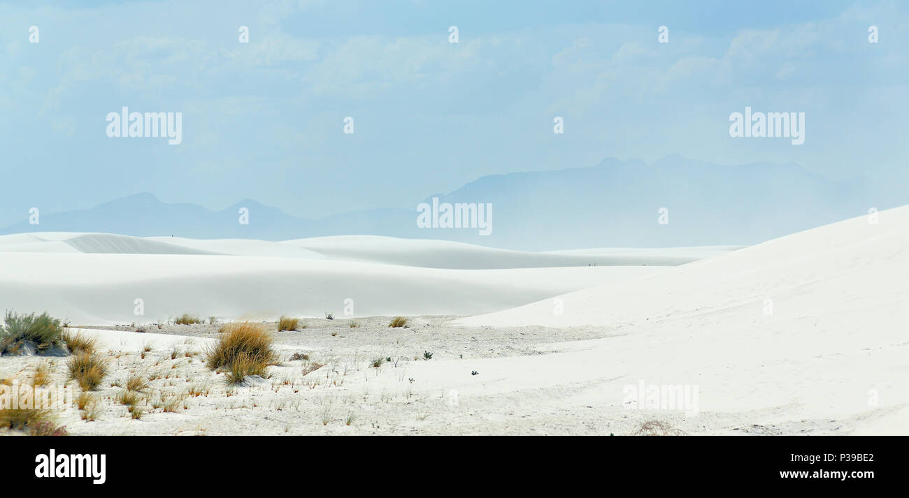 White sand dunes with mountains in the background in southern New Mexico Stock Photo