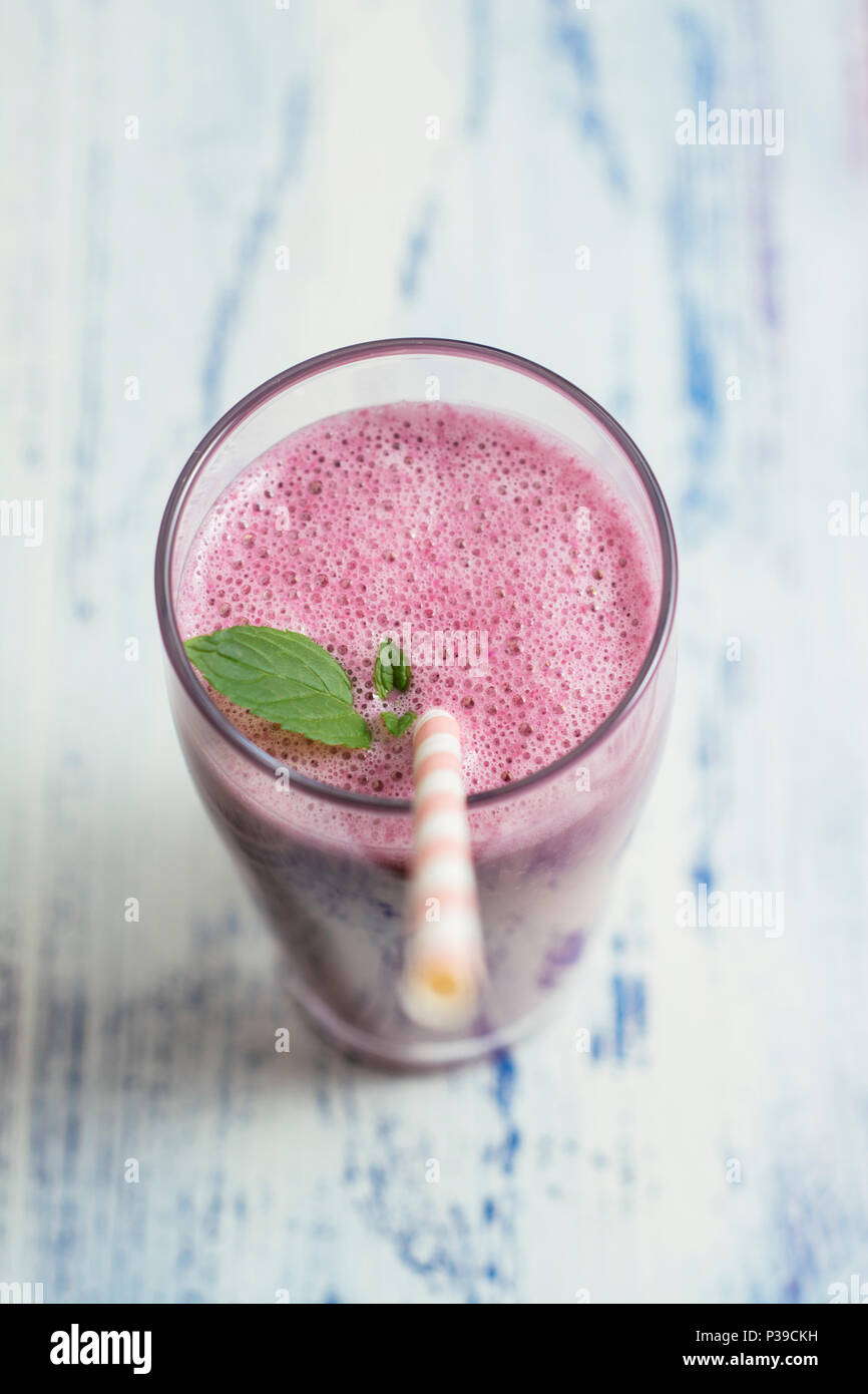 Healthy vegan smoothie with almond milk, oats, banana, elderberry syrup and blackcurrant juice Stock Photo