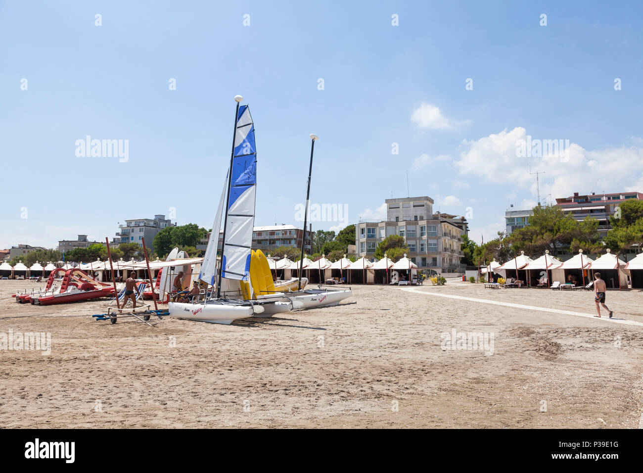 Recreational boats and surf boards for hire on a sandy beach, Lido di Venezia, Venice, Veneto,  Italy Stock Photo
