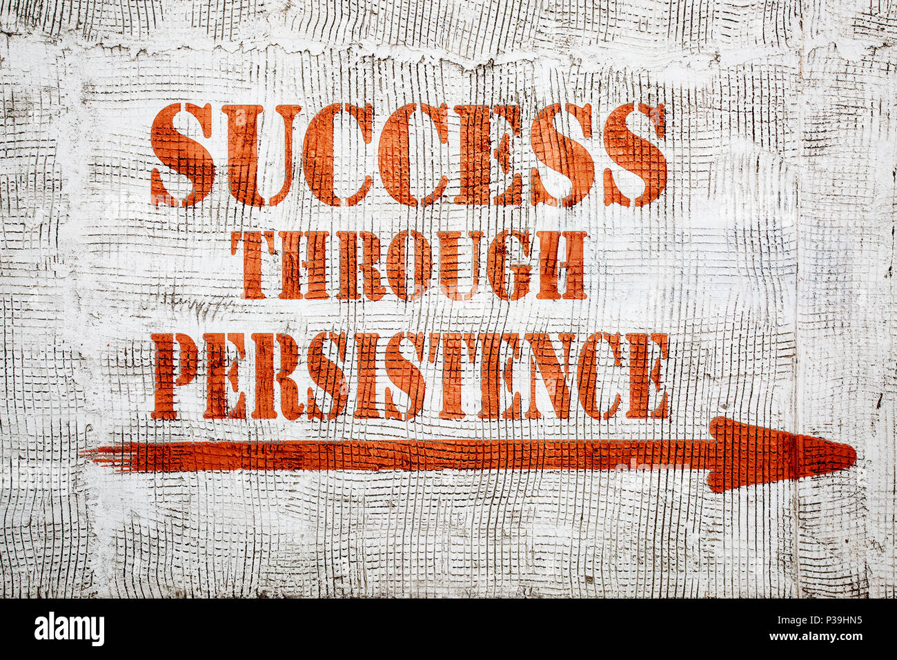 success through persistence - graffiti sign with arrow on stucco wall Stock Photo