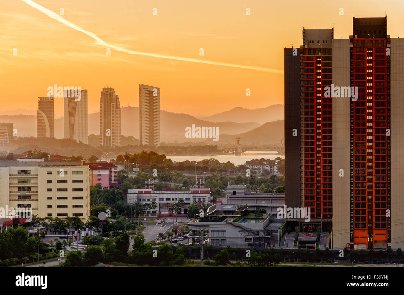 View of modern city at dawn. Beautiful city landscape with high-rise office buildings, green trees in parks. Beginning of day. Malaysia, Cyberjaya. Stock Photo