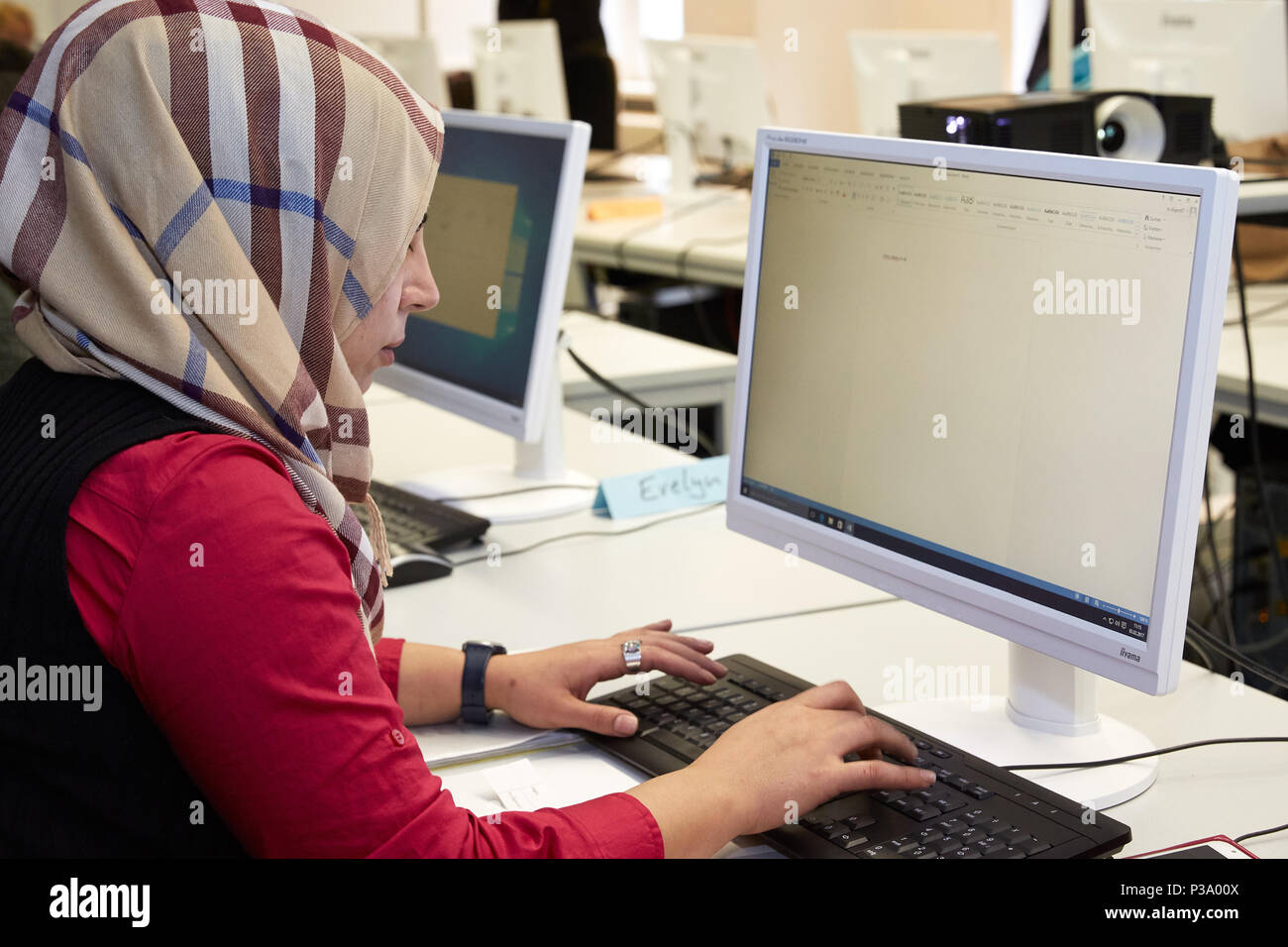 Berlin, Germany, refugee woman learns how to use the computer Stock Photo