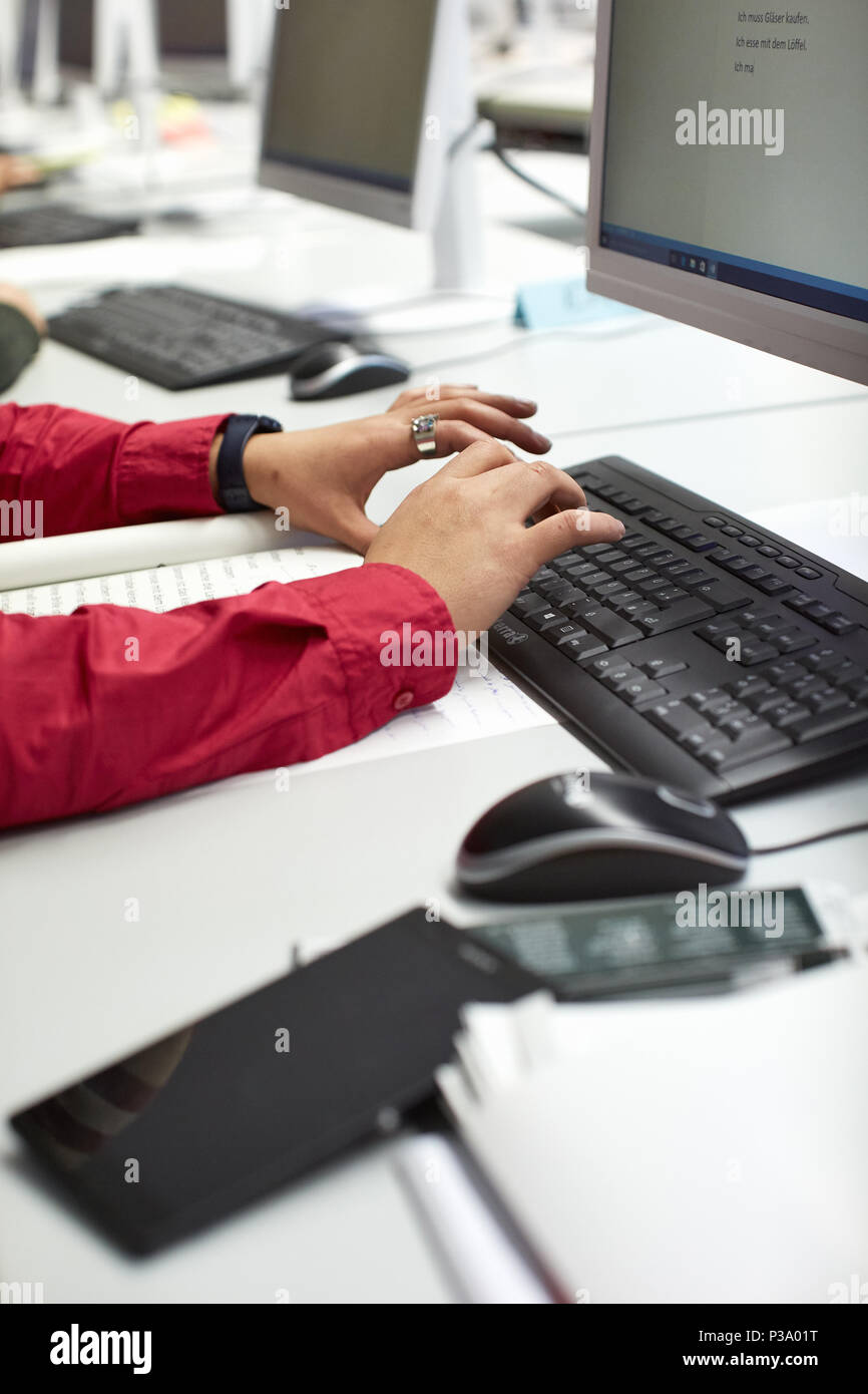 Berlin, Germany, refugee woman learns how to use the computer Stock Photo