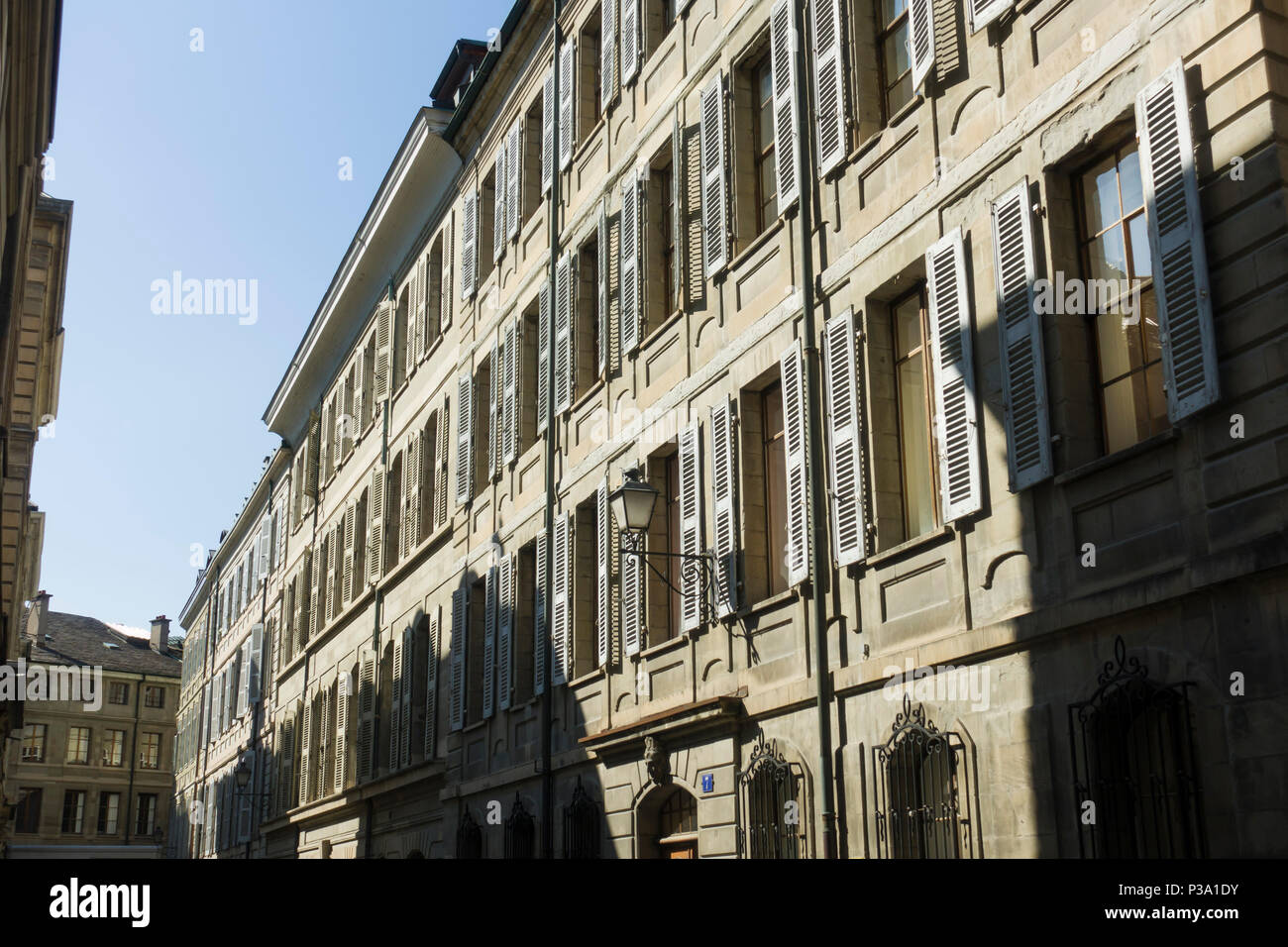 A street of tall stone-fronted buildings in the medieval old town / Cite of Geneva / Geneve, Switzerland. Stock Photo