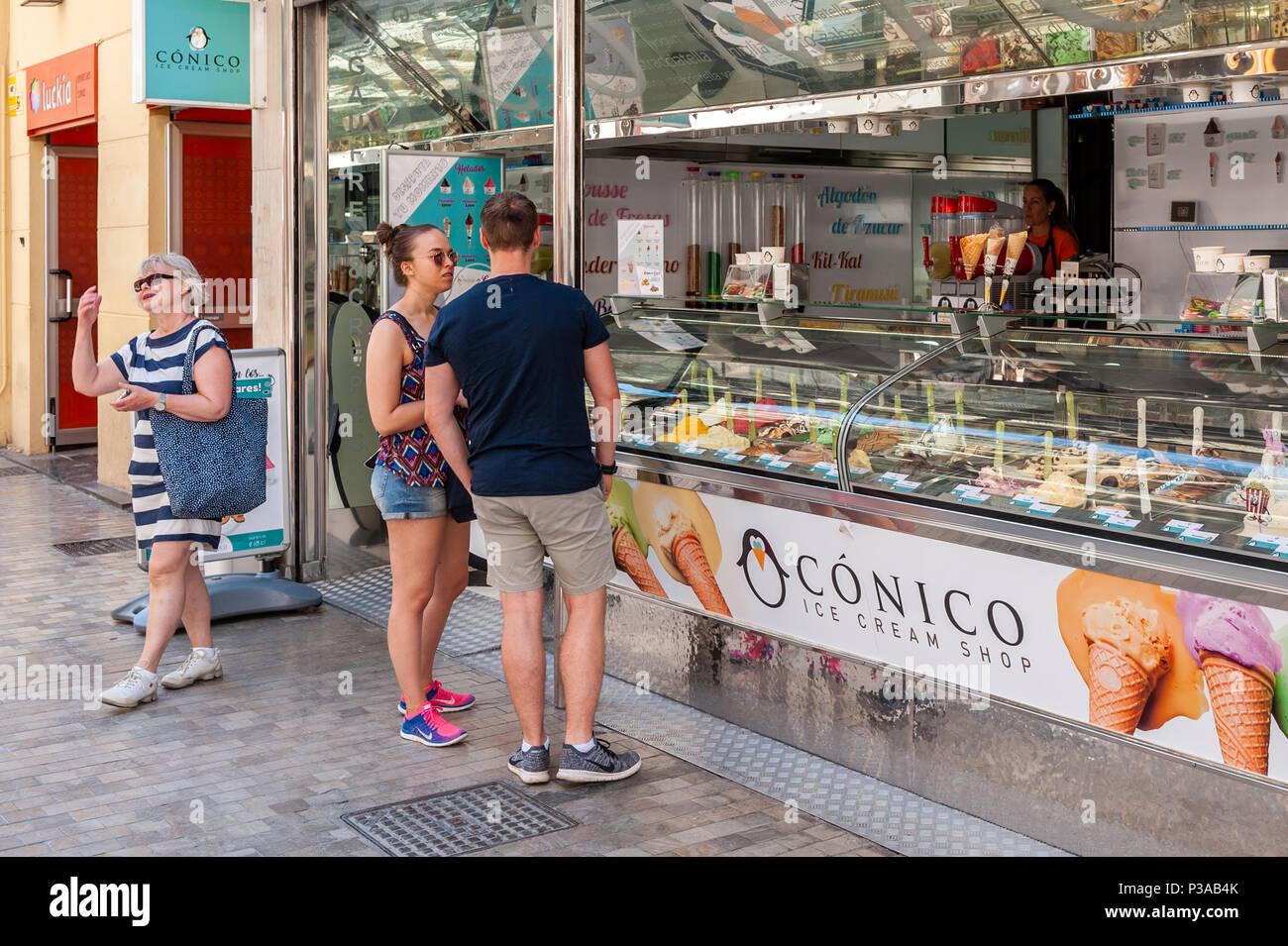 People buying ice cream from Conico Ice Cream shop in the city centre, Malaga, Spain. Stock Photo