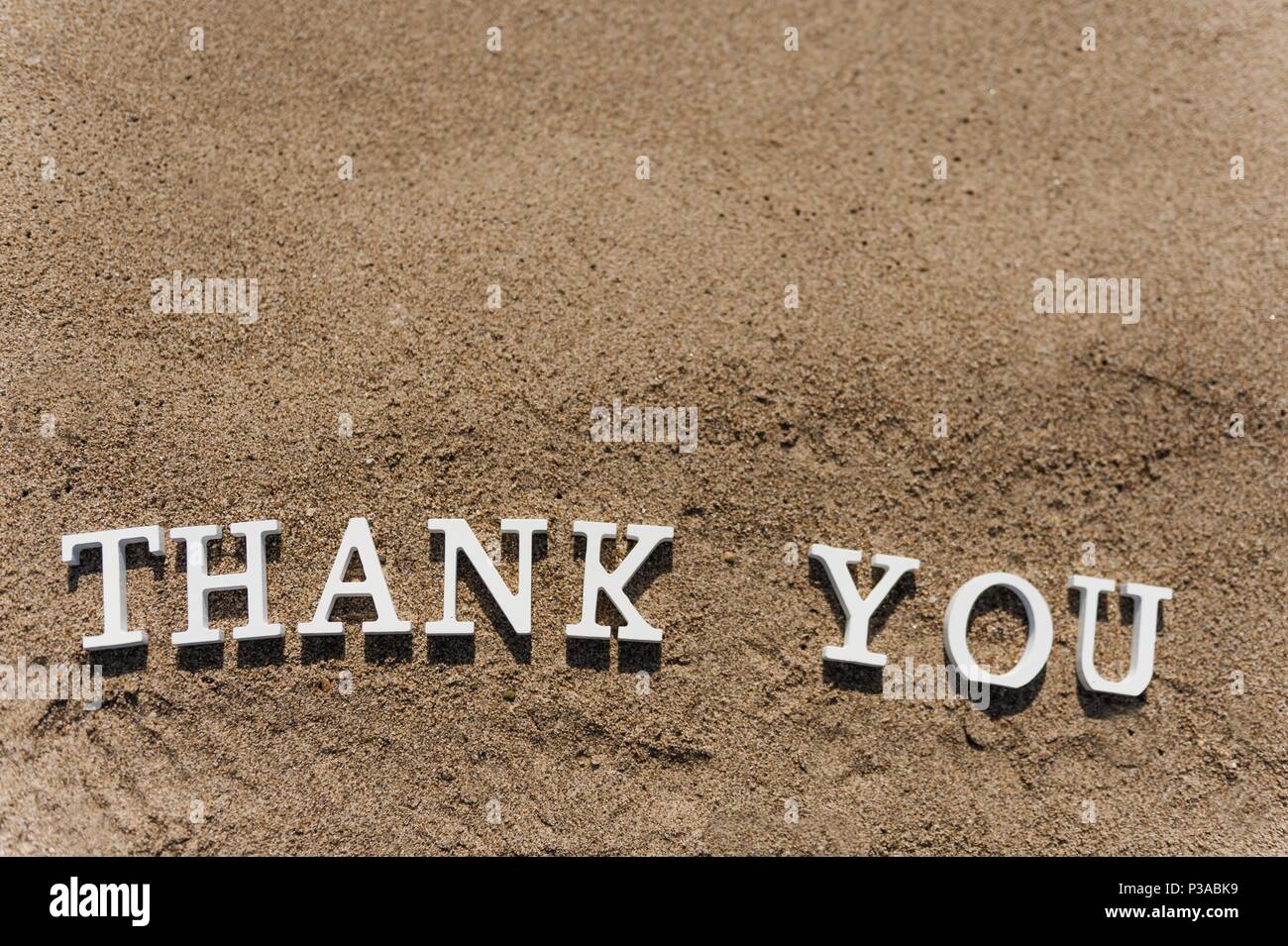 thank you word drawn on the beach sand Stock Photo - Alamy
