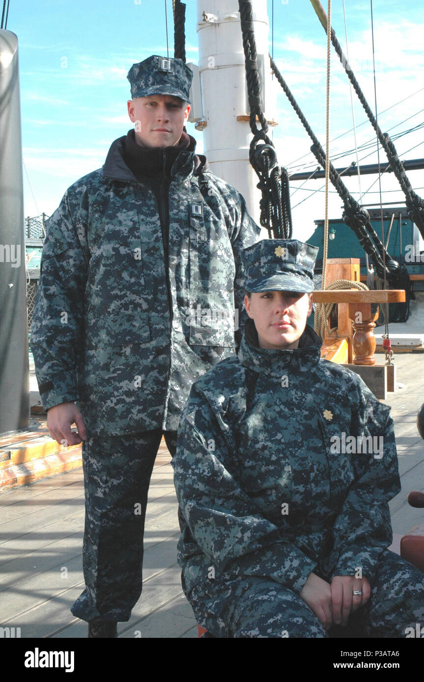(Nov. 1, 2005) Ð Two Sailors pose aboard USS Constitution wearing the blue digital patterned battle dress uniform concept. Chief of Naval Operations Adm. Mike Mullen approved plans for a single working uniform for all ranks, E-1 to O-10, based on recommendations made during a comprehensive briefing in Washington, D.C. by Task Force Uniform Feb. 24. The BDU-style working uniform, designed to replaces seven different styles of current working uniforms, is made of a near maintenance-free permanent press 50/50 nylon and cotton blend.  Worn with a blue cotton t-shirt, it will include an eight-point Stock Photo