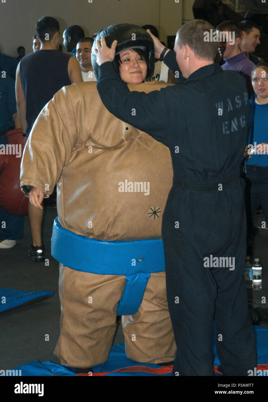 Ocean (Nov. 5, 2006) Ð Aviation Ordnanceman Airman Apprentice Karina Cortes gets suited up for a sumo-wrestling match on board the amphibious assault ship USS Wasp (LHD 1) during a steel beach picnic. Wasp is currently in transit on her way to homeport Norfolk, Va., after completing a humanitarian mission in support of Joint Task Force Lebanon. U.S. Navy Stock Photo