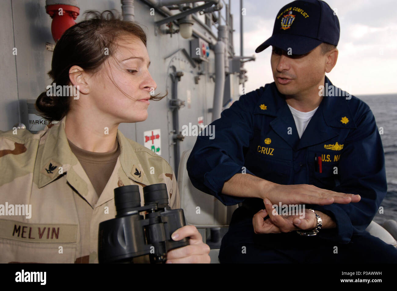 Gulf (Dec. 2, 2006)- USS Ardent (MCM 12) Commanding Officer Lt. Cmdr. Angel Cruz speaks to Mass Communication Specialist 3rd Class Kori Melvin on Officer of the Deck procedures during a mine countermeasure exercise. The exercise is being conducted in support of maritime security operations (MSO). MSO help set the conditions for security and stability in the maritime environment as well as complement the counter-terrorism and security efforts of regional nations. U.S. Navy Stock Photo